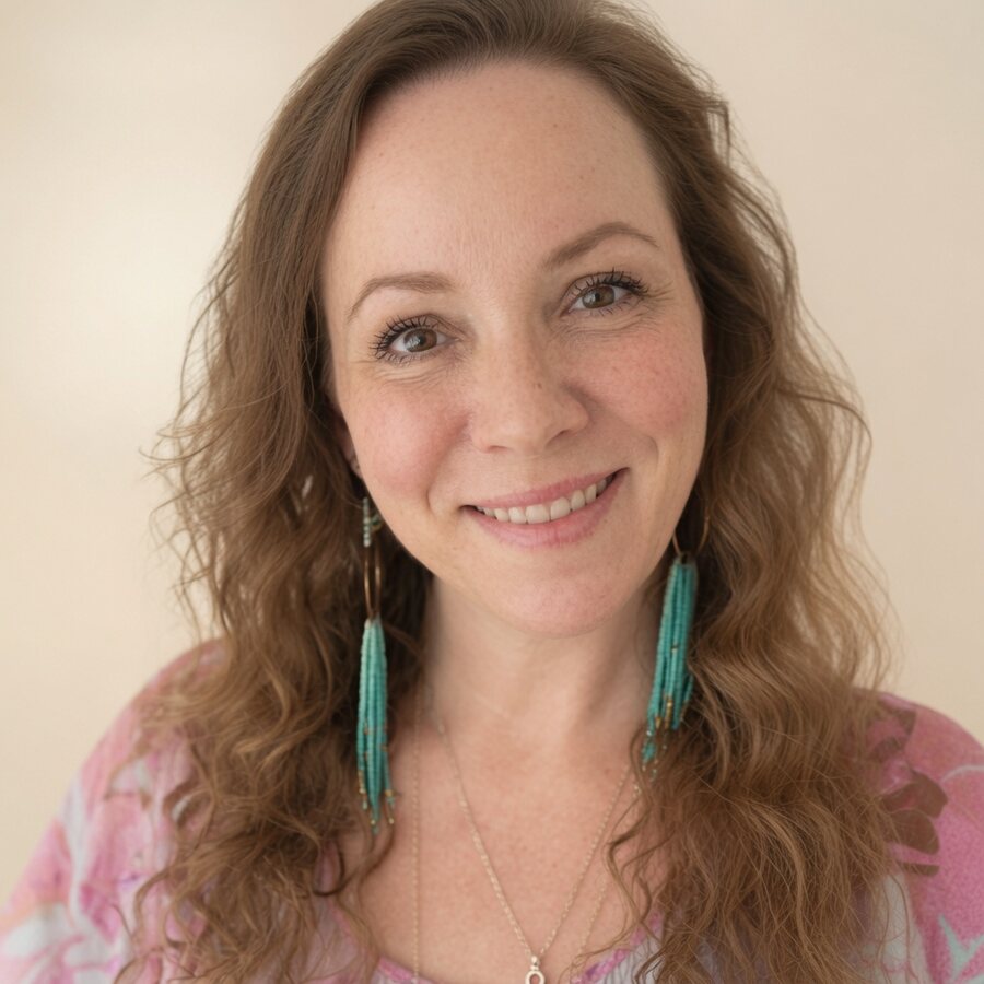 Portrait of Angela Bolton smiling, wearing long turquoise earrings